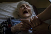 An elderly woman who has been evacuated from the Lysychansk area cries moments before departing by train to western Ukraine from the Pokrovsk railway station, Friday, June 10, 2022. (AP Photo/Bernat Armangue)