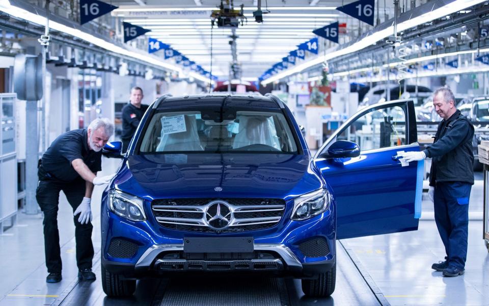 Workers check a Mercedes SUV at the company's Bremen factory - Bloomberg News