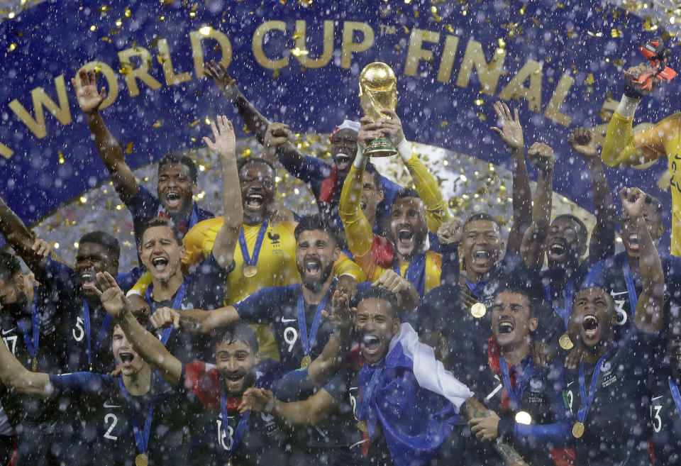 FILE - In this July 15, 2018, file photo, France goalkeeper Hugo Lloris holds the trophy aloft after the final match between France and Croatia at the 2018 soccer World Cup in the Luzhniki Stadium in Moscow, Russia. A year after hosting the World Cup, Russia is boasting the biggest club soccer crowds since Soviet days and participation at the amateur level is on the rise. Still, there are signs of trouble for the sport. (AP Photo/Matthias Schrader, File)