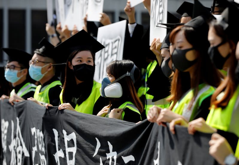 Graduates wearing masks hold an anti-government rally after their graduation ceremony at the Chinese University of Hong Kong in Hong Kong