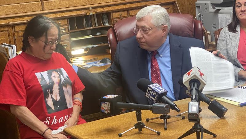 Attorney Robert Sykes comforts Marjorie Charles-Scott, the mother of Shandon Nicole Scott, who was killed two years ago Monday. Charles-Scott and others filed a lawsuit claiming violent offenders who should remain in prison were being released and not properly supervised once they were out.