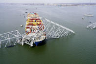 In this aerial image released by the Maryland National Guard, the cargo ship Dali is stuck under part of the structure of the Francis Scott Key Bridge after the ship hit the bridge, Tuesday, March 26, 2024, in Baltimore. (Maryland National Guard via AP)