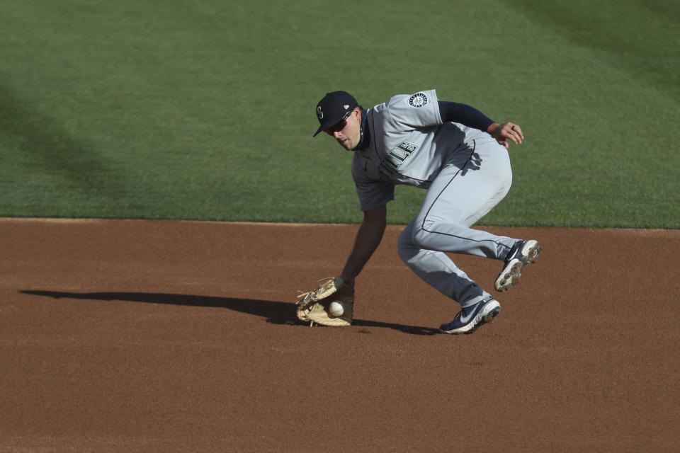 Seattle Mariners' Evan White fields a ball hit by Oakland Athletics' Tony Kemp during the first inning of the second baseball game of a doubleheader in Oakland, Calif., Saturday, Sept. 26, 2020. (AP Photo/Jed Jacobsohn)