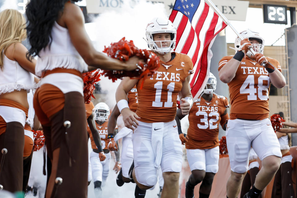 Texas Longhorns QB Sam Ehlinger and his brother Jake Ehlinger run onto the field before the game against the Louisiana Tech Bulldogs on Saturday. (Getty)