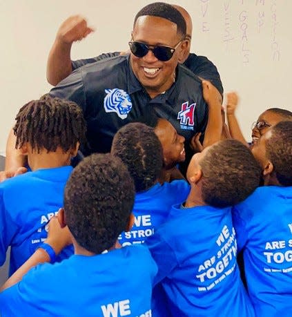 Percy "Master P" Miller interacts with kids at the camp he and his son Hercy hosted at Tennessee State's Gentry Center.