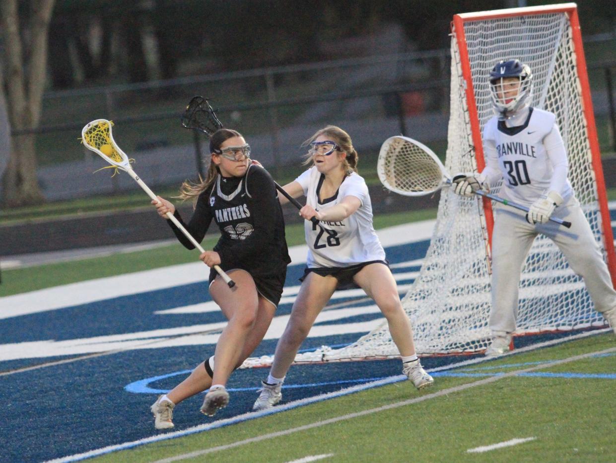 Pickerington North's Keira Bryant attempts to maneuver past Granville's Olivia Hoyt while Ellie Alexander protects the net on Thursday.