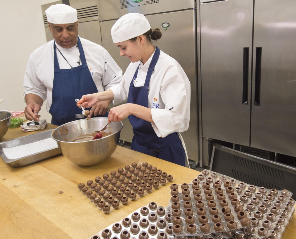 Pastry chef Selwyn Stoby and an assistant prepare some kirsch-filled truffles. (Photo: PA Images)