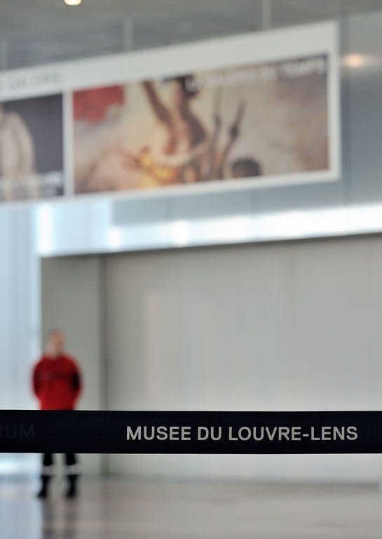 A security guard blocks the entrance of the "Galerie du Temps" at the Louvre-Lens Museum in the French northern city of Lens, on February 8, 2013. The museum has been closed after an attack on a Delacroix masterpiece