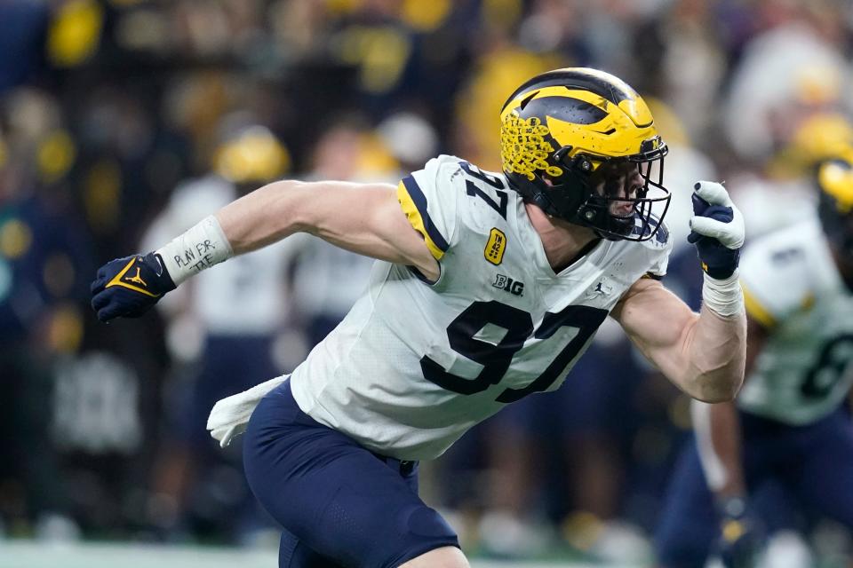 Michigan defensive end Aidan Hutchinson (97) rushes up field during the second half of the Big Ten championship NCAA college football game against Iowa.