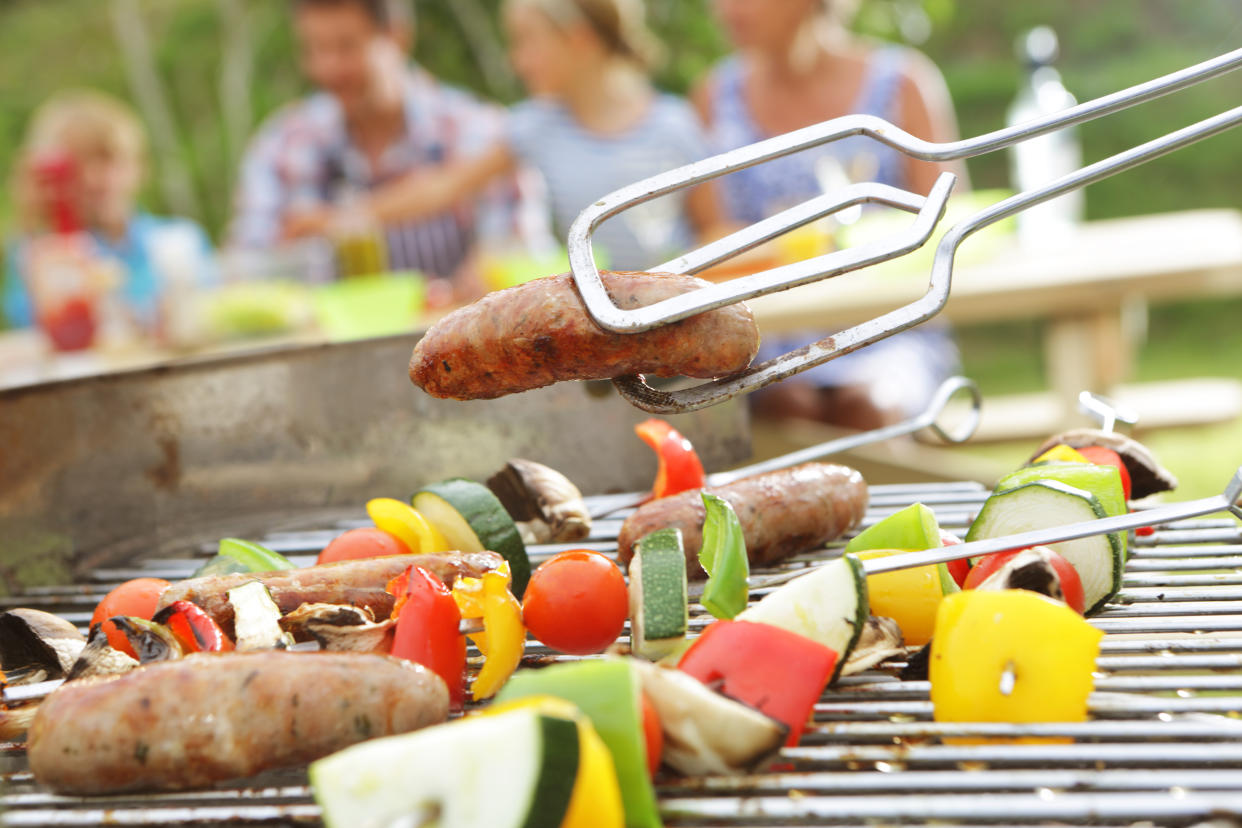 Family having BBQ in garden, close up of food