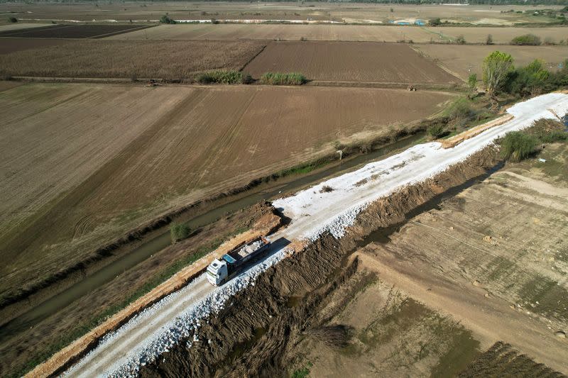 FILE PHOTO: A truck carries stones to reinforce embankments at Thessaly plain