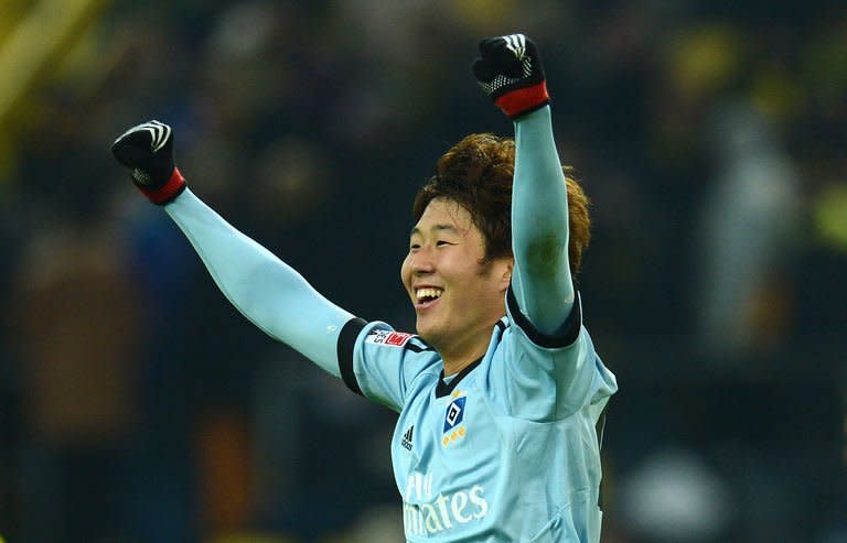 Hamburg's Korean striker Son Heung-Min celebrates at the end of the German first division Bundesliga football match against Borussia Dortmund in Dortmund on February 9, 2013. Defending champions Borussia Dortmund suffered a shock 4-1 defeat at home to Hamburg in the Bundesliga on Saturday with Son claiming two goals as both teams finished with 10 men