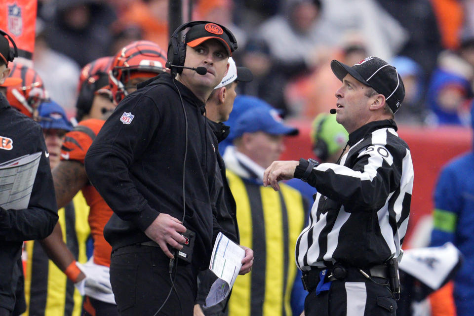 Cincinnati Bengals head coach Zac Taylor, left, listens to field judge Aaron Santi during the first half of an NFL football game against the Pittsburgh Steelers in Cincinnati, Sunday, Nov. 26, 2023. (AP Photo/Jeffrey Dean)