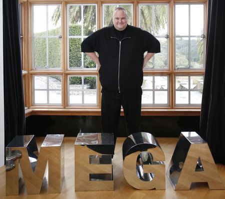 Kim Dotcom poses near blocks of letters as he talks exclusively to Reuters during his Internet Party pool party at the Dotcom mansion in Coatesville, Auckland April 13, 2014. REUTERS/Nigel Marple/Files