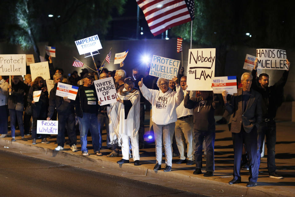 Protestors cheer during a demonstration in support of special counsel Robert Mueller, Thursday, Nov. 8, 2018, in Las Vegas. Protesters have converged in cities nationwide to call for the protection of Mueller's investigation into potential coordination between Russia and President Donald Trump's campaign. (AP Photo/John Locher)