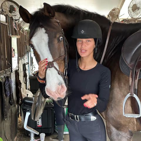 <p>Bella Hadid/Instagram</p> Bella Hadid poses with a horse at Wellington International, an equestrian club in Florida.