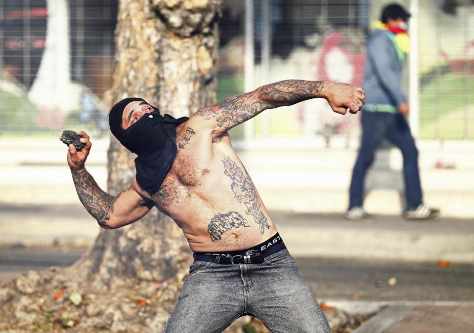 Demonstrators confront police as they protest against the government of President Nicolas Maduro in Caracas