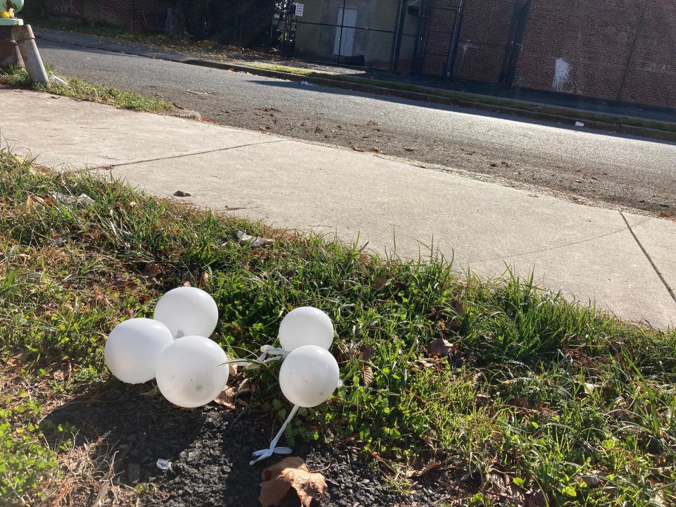 Deflated balloons sit outside the Pride of Camden Elks Lodge, where a 14-year-old attended a birthday party and was fatally shot Saturday night.