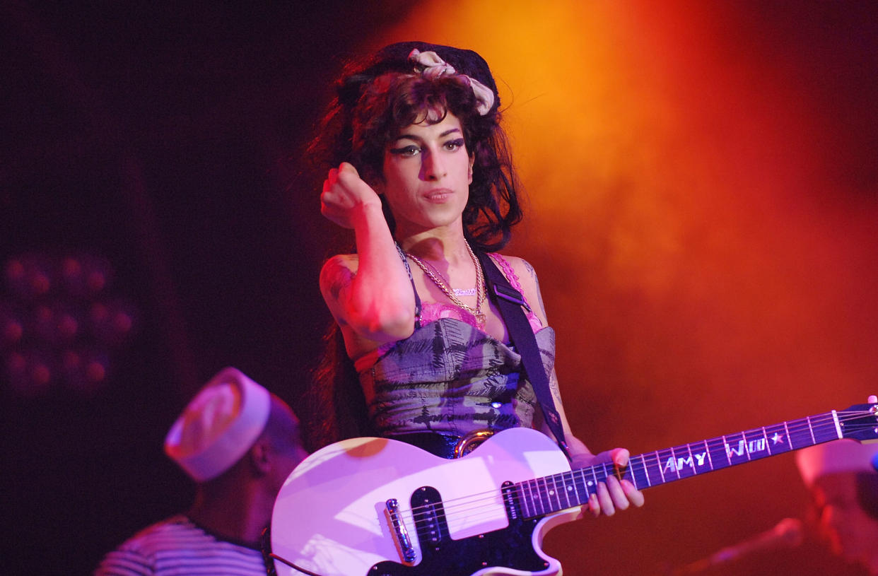 NEWPORT, UNITED KINGDOM - SEPTEMBER 06:  Amy Winehouse headlines the main stage on day 2 of Bestival on the Isle of Wight, England.  (Photo by Samir Hussein/Getty Images)