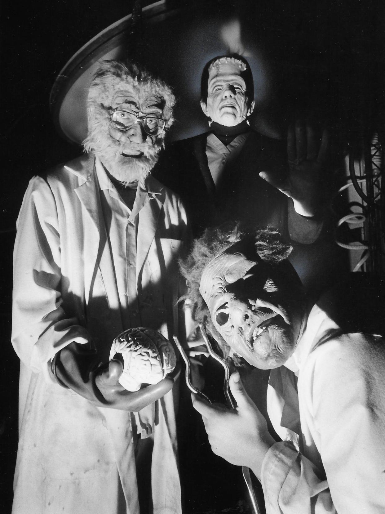 Dr. Frankenstein (Clinton Grant), Frankenstein's monster (Jeff Knight) and Igor (Kyle Hysell) await victims at the Haunted Schoolhouse in Akron on Oct. 9, 1980.