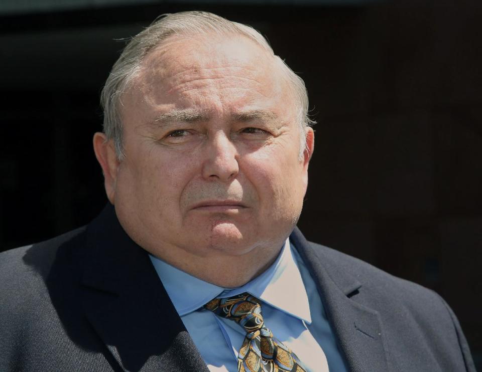 Former Bell city manager Robert Rizzo, listens to questions from the media, as he leaves the Edward R. Roybal Federal building and United States courthouse Monday, April 14, 2014. Rizzo was sentenced to 33 months in prison for income tax evasion on Monday. On Wednesday Rizzo faces sentencing in state court on 69 counts of fraud, misappropriation of public funds and other charges for his role in the Bell scandal. He pleaded no contest in that case in October. (AP Photo/Nick Ut)