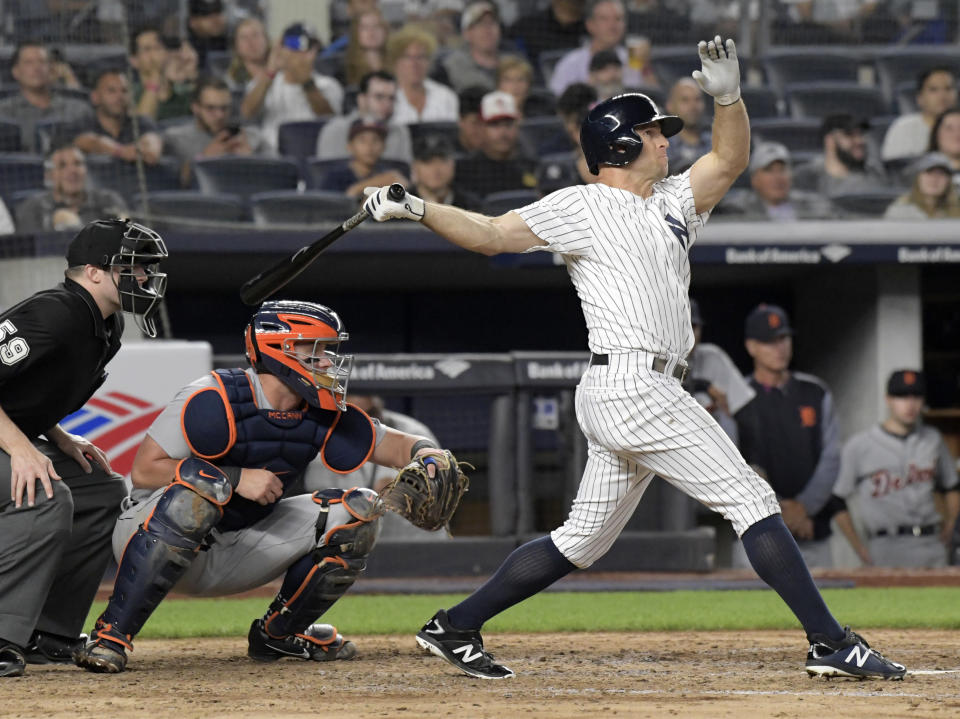 New York Yankees' Brett Gardner, right, hits a two-run home run as Detroit Tigers catcher James McCann, center, and umpire Nic Lentz, left, look on during the sixth inning of a baseball game Friday, Aug. 31, 2018, at Yankee Stadium in New York. (AP Photo/Bill Kostroun)
