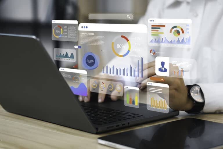 An analyst uses a computer and dashboard for data business analysis and Data Management System with KPI and metrics connected to the database for technology finance, operations, sales, marketing, and artificial intelligence.