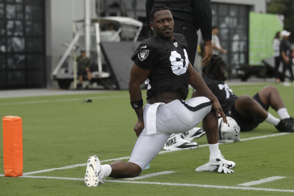 Oakland Raiders' Antonio Brown stretches during NFL football practice in Alameda, Calif., Tuesday, Aug. 20, 2019. (AP Photo/Jeff Chiu)