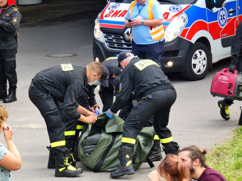 First responders attend to the scene of a public bus crash in Warsaw