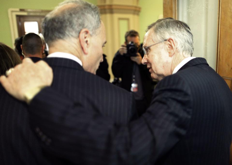 U.S. Senate Majority Leader Harry Reid (D-NV) (R) walks with his arm around Senator Charles Schumer (D-NY) as they depart following a news conference after bipartisan passage of budget and debt legislation at the U.S. Capitol in Washington, October 16, 2013. The U.S. Senate approved a deal on Wednesday to end a political crisis that partially shut down the federal government and brought the world's biggest economy to the edge of a debt default that could have threatened financial calamity. REUTERS/Jonathan Ernst (UNITED STATES - Tags: POLITICS BUSINESS)