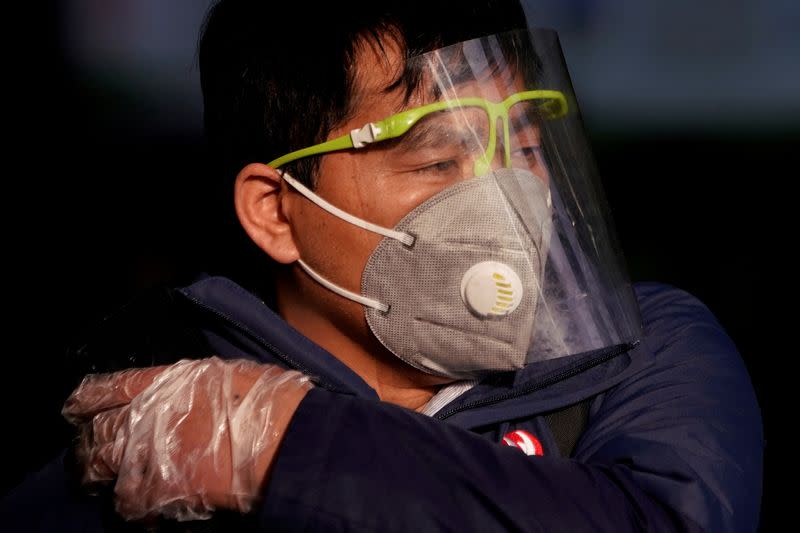 FILE PHOTO: A man wearing a mask is seen at the Shanghai railway station in Shanghai