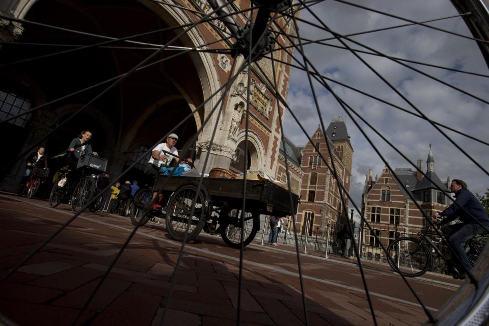 Bicycles pass through Rijksmuseum, in Amsterdam, Netherlands, Monday May 13, 2013, signaling the end of more than a decade of efforts by cyclists to ensure a passageway that runs under and through the Rijksmuseum would remain open to bike traffic. The museum, which houses masterpieces by Rembrandt van Rijn and Vincent van Gogh, among others, opened last month after a 10-year renovation. Architects and successive museum directors had opposed allowing bikes through, and a local government tried to have them barred on safety grounds. But in a city that has more bicycles than people, the bike lobby prevailed. (AP Photo/Peter Dejong)