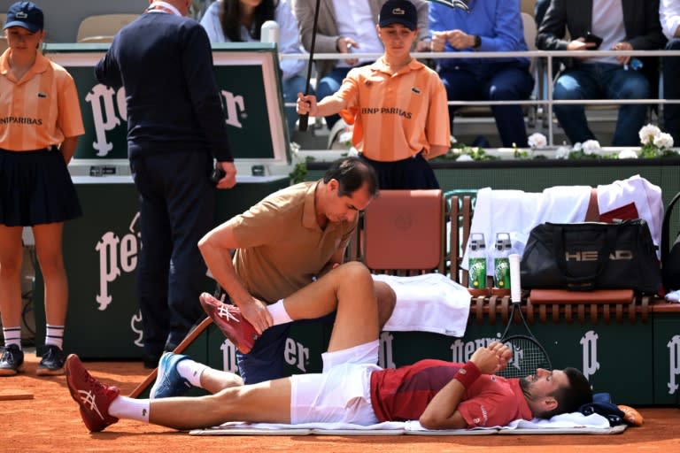 Novak Djokovic received treatment during his victory against Francisco Cerundolo at the French Open after which he withdrew with a knee injury (Bertrand GUAY)