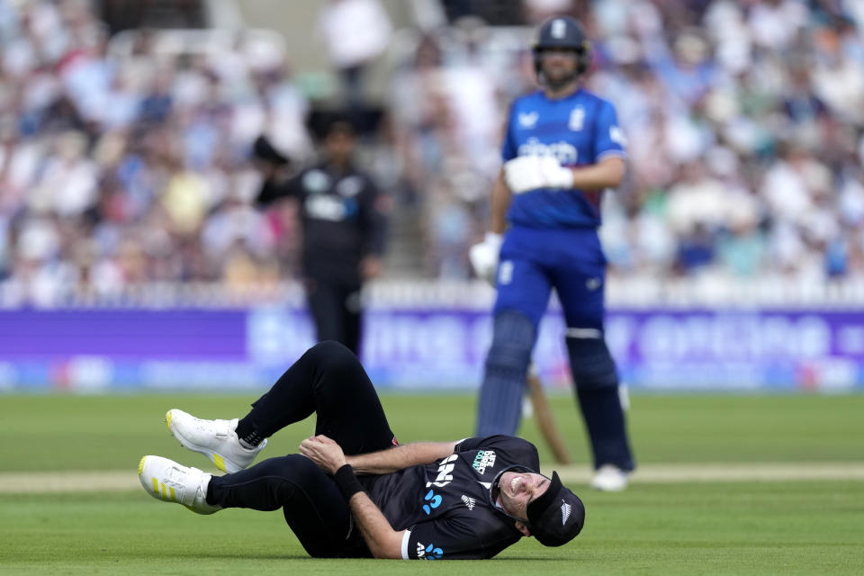 New Zealand's Tim Southee is injured after he fails to catch out England's Joe Root during the One Day International cricket match between England and New Zealand at Lord's cricket ground in London, Friday, Sept. 15, 2023. (AP Photo/Kirsty Wigglesworth)