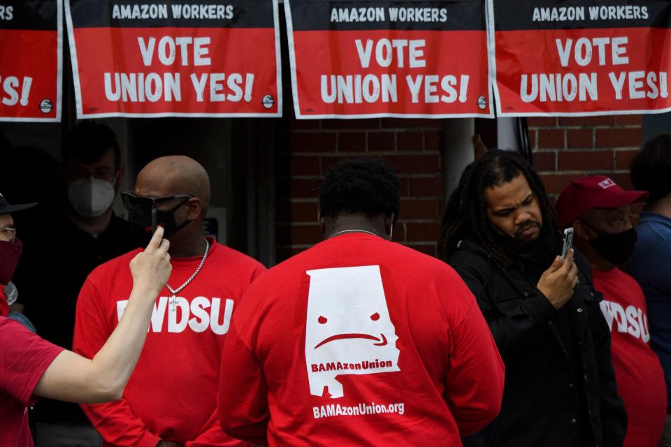 Organizers wear shirts in support of the unionization of Amazon.com, Inc. fulfillment center workers outside Retail, Wholesale and Department Store Union (RWDSU) office in Birmingham, Alabama on March 26, 2021. - Senator Bernie Sanders joined the drive March 26, 2021, to unionize Amazon workers in Alabama with the Retail, Wholesale and Department Store Union (RWDSU) in Birmingham, as clashes intensified between lawmakers and the e-commerce giant ahead of a deadline for a vote that could lead to the first union on US soil at the massive tech company. The visit marks the latest high-profile appearance in the contentious organizing effort for some 5,800 employees at Amazon's warehouse in Bessemer which culminates next week. (Photo by Patrick T. FALLON / AFP) (Photo by PATRICK T. FALLON/AFP via Getty Images)