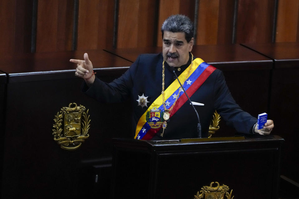 FILE - Venezuelan President Nicolas Maduro holds a small copy of his nation's constitution during ceremony marking the start of the judicial year at the Supreme Court in Caracas, Venezuela, Jan. 31, 2024. A secret memo obtained by The Associated Press details a covert operation by the U.S. Drug Enforcement Administration that sent undercover operatives into Venezuela to record and build drug-trafficking cases against the country’s leadership including Venezuelan President Nicolás Maduro. (AP Photo/Ariana Cubillos, File)