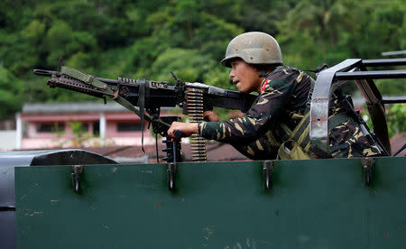 A government soldier holds a weapon aboard an armoured fighting vehicle (AFV) as soldiers advance their position in Marawi City, Philippines May 28, 2017. REUTERS/Erik De Castro