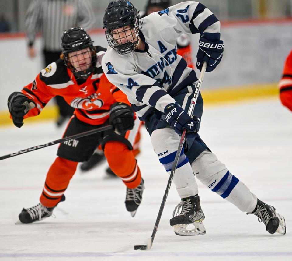 BOURNE  02/07/24 Christopher Cardillo of Sandwich races ahead of Ethan deNormand of Middleborough. boys hockey
Ron Schloerb/Cape Cod Times