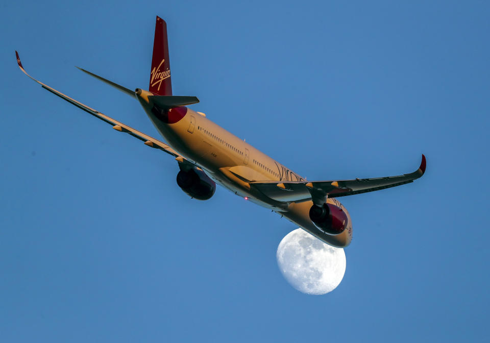 A Virgin Atlantic Airbus A350-1041 with registration G-VLUX passes the moon as it takes off from Heathrow Airport. PA Photo. Picture date: Thursday February 6, 2020. Photo credit should read: Steve Parsons/PA Wire (Photo by Steve Parsons/PA Images via Getty Images)