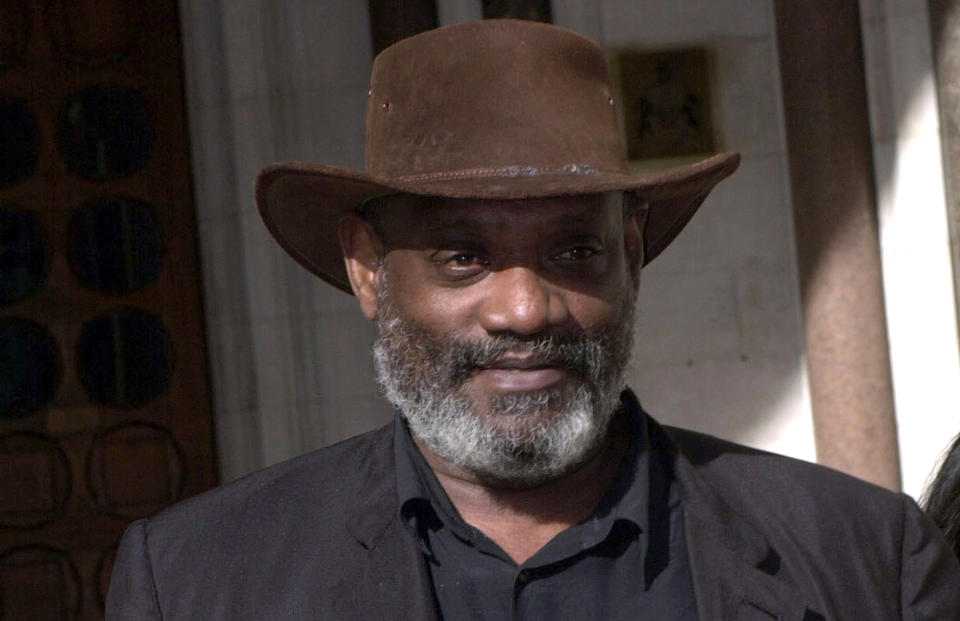 FILE - In this March 3, 2000 file photo, author and broadcaster Darcus Howe walks, in London. The biographer of British black activist Howe says he has died. He was 74 and had been suffering from prostate cancer, it was reported on Sunday, April 2, 2017. (Stefan Rousseau/PA via AP, File)