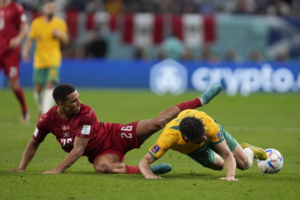 Australia's Mathew Leckie, right, is talked by Denmark's Alexander Bah during the World Cup group D soccer match between Australia and Denmark, at the Al Janoub Stadium in Al Wakrah, Qatar, Wednesday, Nov. 30, 2022. (AP Photo/Thanassis Stavrakis)