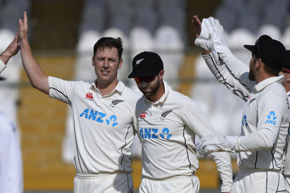 New Zealand's Matt Henry, left, celebrates with teammates after taking the wicket of Pakistan's Abdullah Shafique during the second day of the second test cricket match between Pakistan and New Zealand, in Karachi, Pakistan, Tuesday, Jan. 3, 2023. (AP Photo/Fareed Khan)