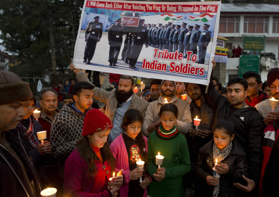 Indians observe a minute's silence in memory of Indian paramilitary soldiers killed in Kashmir, in Dharmsala, India, Saturday, Feb. 16, 2019. India's prime minister warned of a "crushing response" to the suicide bombing of a paramilitary convoy in Indian-controlled Kashmir that killed 41 people and was the deadliest in the divided region's volatile history. (AP Photo/Ashwini Bhatia)