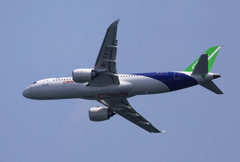 FILE PHOTO: A Comac C919 flies past during an aerial flying display ahead of the Singapore Airshow at Changi Exhibition Centre in Singapore