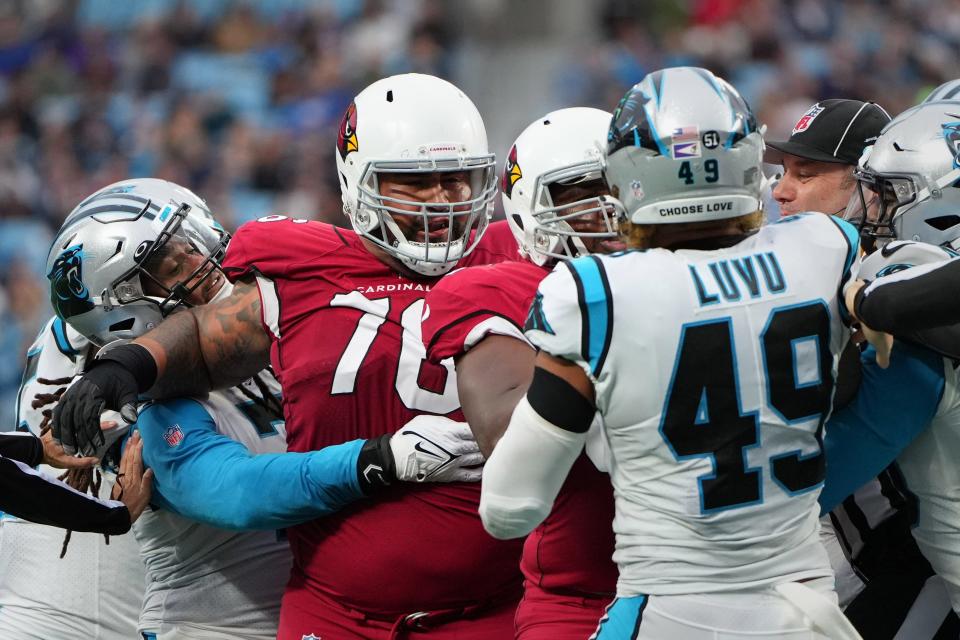 Oct 2, 2022; Charlotte, North Carolina, USA; Carolina Panthers linebacker Shaq Thompson (7) holds back Arizona Cardinals guard Will Hernandez (76) as offensive tackle Kelvin Beachum (68) steps between Carolina Panthers linebacker Frankie Luvu (49) in the fourth quarter at Bank of America Stadium. Luvu was called for unnecessary roughness on the play and Hernandez was disqualified on the play.