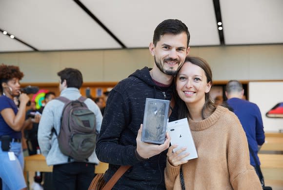 A couple holding their iPhone 8 Plus boxes on Apple's iPhone 8 lanch day