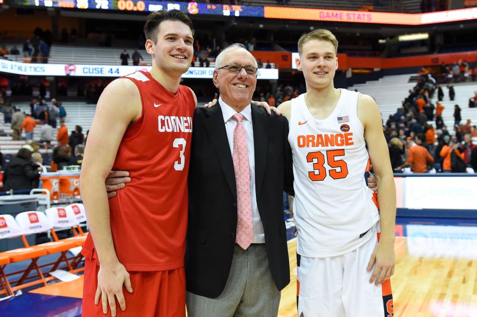 Cornell Big Red forward Jimmy Boeheim (3) and Syracuse Orange head coach Jim Boeheim and Syracuse Orange guard Buddy Boeheim (35) pose for a photo following the game at the Carrier Dome.