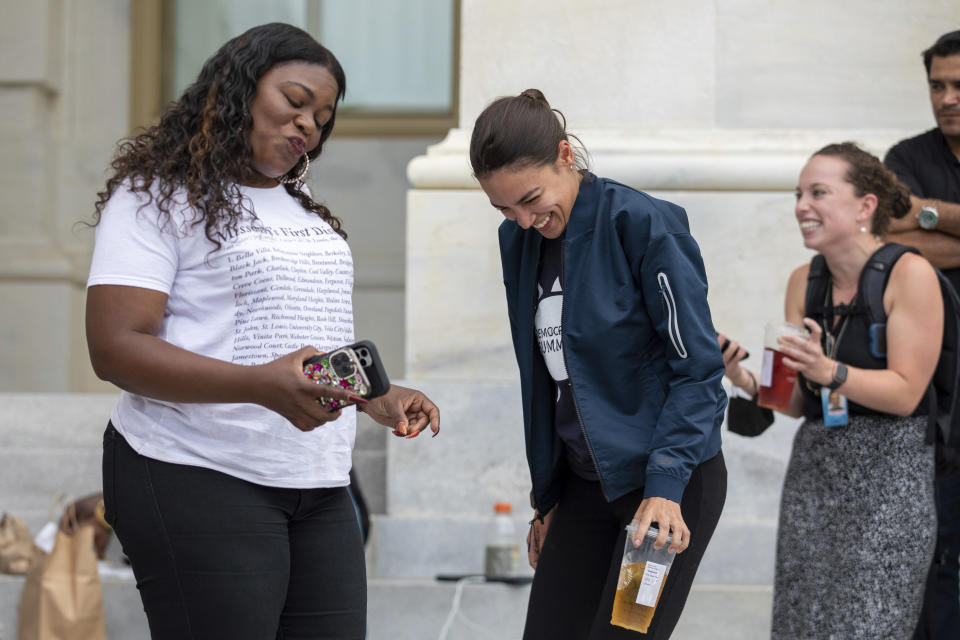 Rep. Cori Bush, D-Mo., and Rep. Alexandria Ocasio-Cortez, D-N.Y., have an impromptu dance party to "Run the World (Girls)" by Beyonce after it was announced that the Biden administration will enact a targeted nationwide eviction moratorium outside of Capitol Hill in Washington on Tuesday, August 3, 2021. For the past five days, lawmakers and activists primarily led by Rep. Cori Bush, D-Mo., have been sitting in on the steps of Capitol Hill to protest the expiration of the eviction moratorium. (AP Photo/Amanda Andrade-Rhoades)