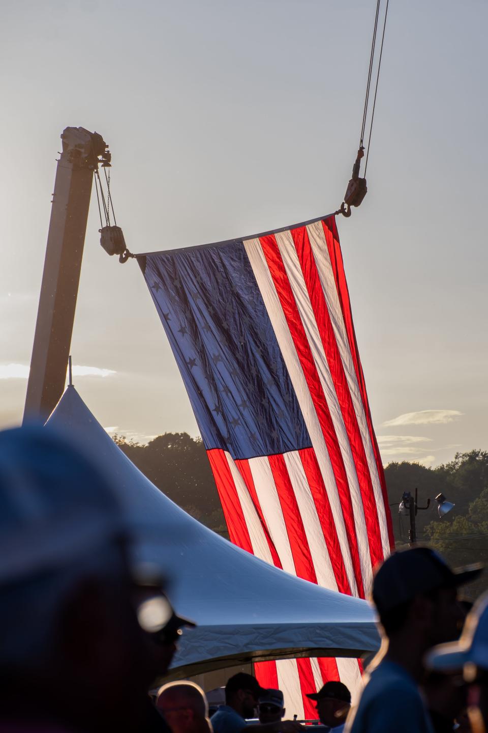 A large flag is suspended behind the stage, catching the wind just right for all to see at the music festival. For more photos visit www.zanesvilletimesrecorder.com