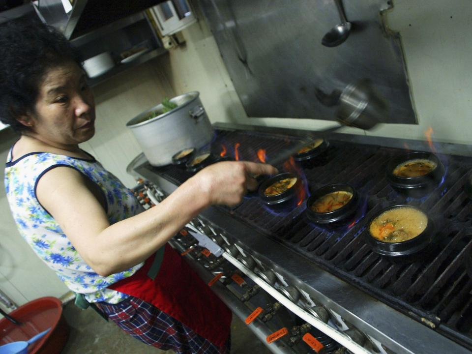 A chef cooks dog meat at a restaurant in South Korea.